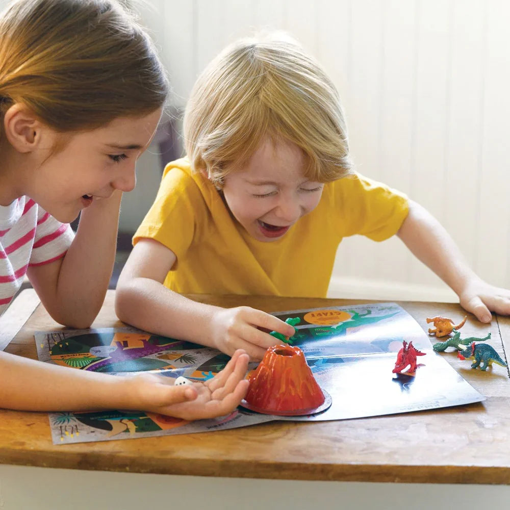 Kids using dinosaur STEAM kit, painting and placing toy dinosaurs on a mat