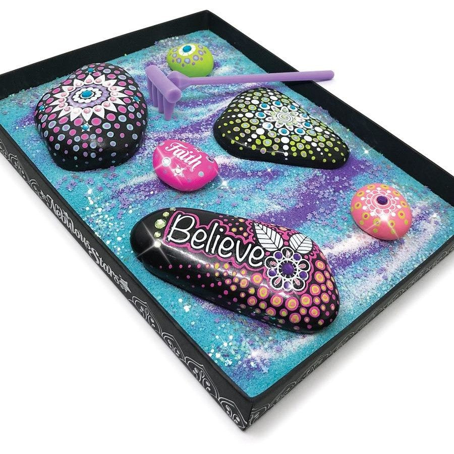 Cosmic Zen Garden tray with colorful painted stones, purple tool, and pink heart stone