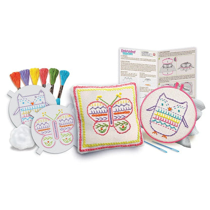 Embroidery stitch kit contents: stitched patches, hoop, and six colorful thread bundles