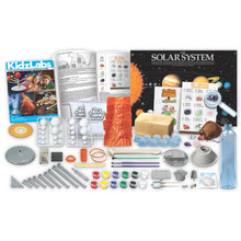 Solar system science lab kit with instruction booklet, tools, and small parts tray