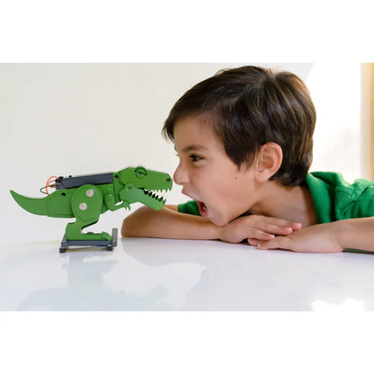 Green dinosaur-style robot toy with claw arm, child playing