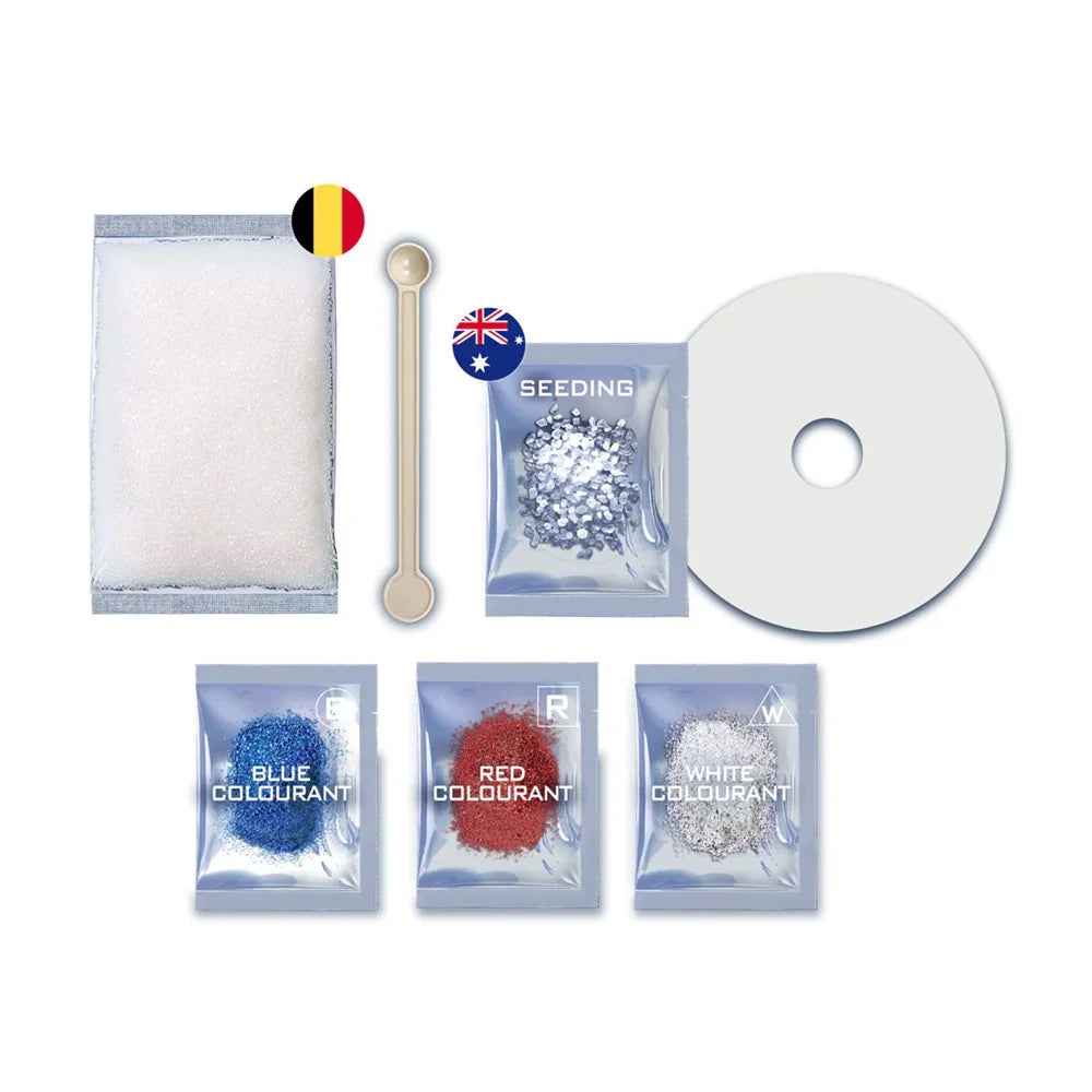 Crystal growing kit contents with seeding crystals, foam pad, and stir stick