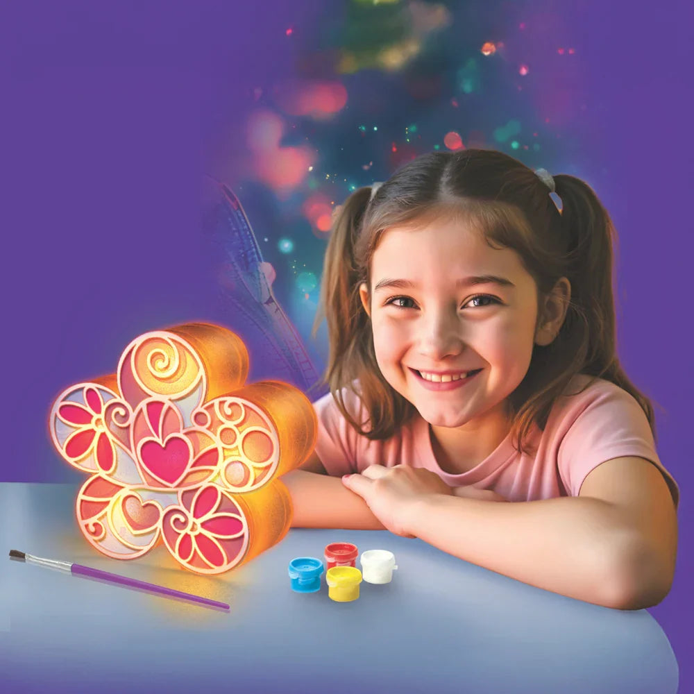 Child using a glowing flower lamp with colorful LED light and paint pens