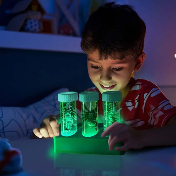 Kids digging lab kit with glowing green specimen tubes and tweezers